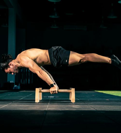 Man performing a controlled strength exercise in a calm environment.